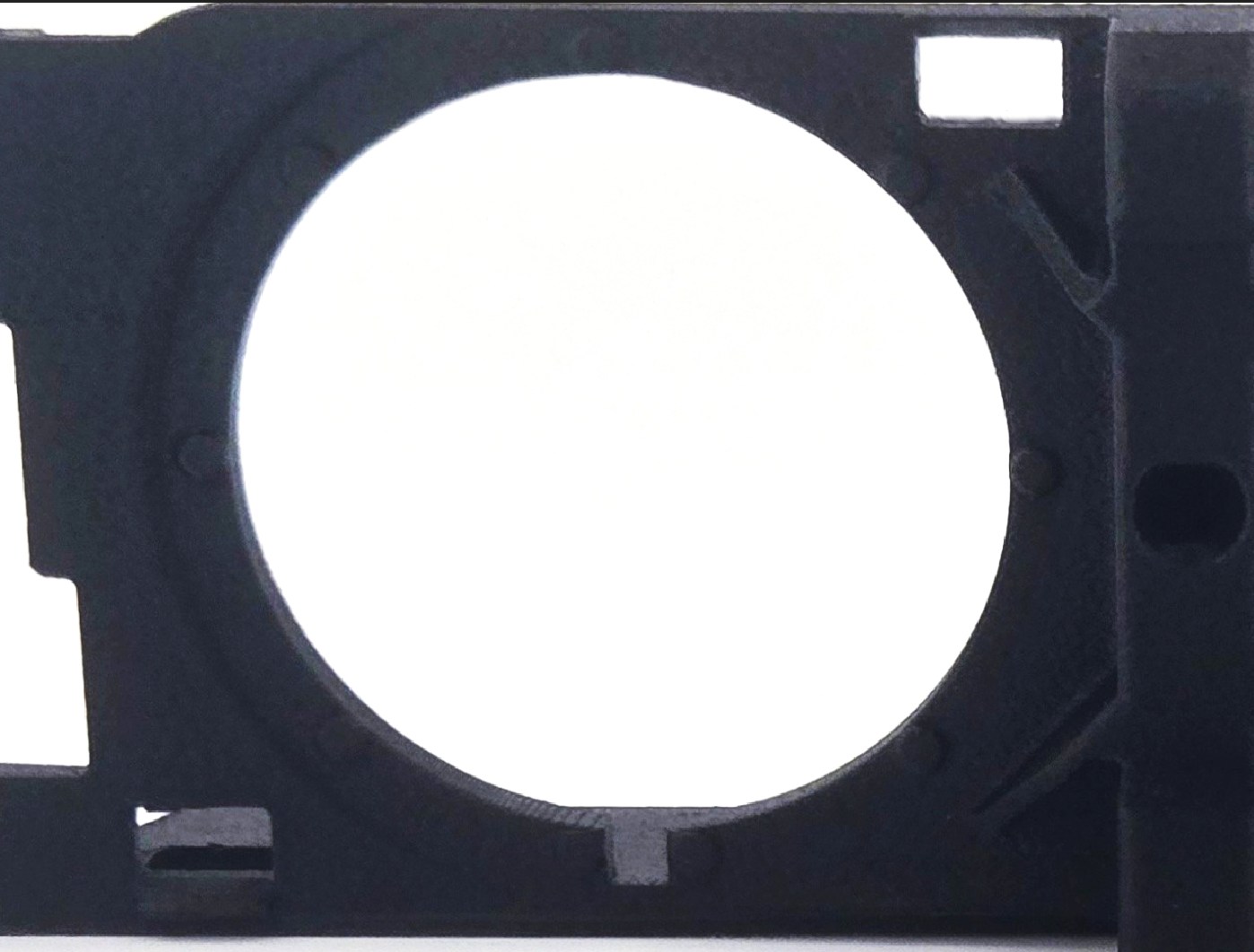 Close-up of a 52mm gauge opening on the Volvo 240 triple gauge bracket, showing the locating slot at the bottom that clocks factory gauges